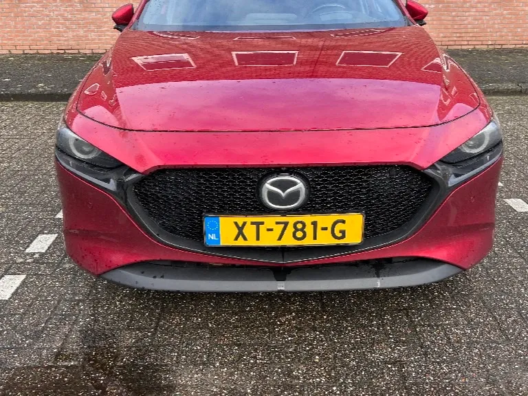 Front view of a red Mazda 3 with Dutch plate XT-781-G